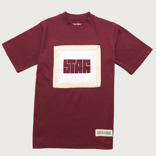 Crimson t-shirt with a square logo on a light gray background